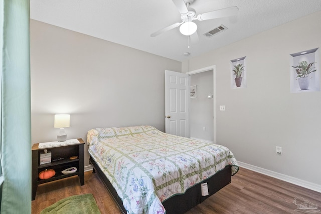 bedroom featuring ceiling fan and dark wood-type flooring