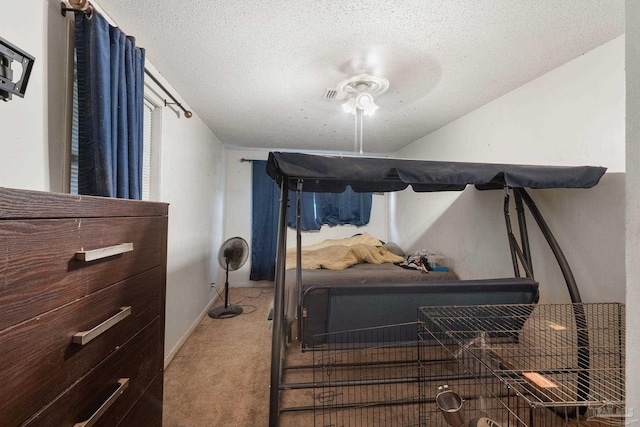 bedroom with ceiling fan, a textured ceiling, and carpet floors