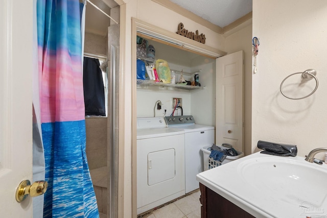 bathroom with washing machine and dryer, a textured ceiling, walk in shower, vanity, and tile patterned flooring