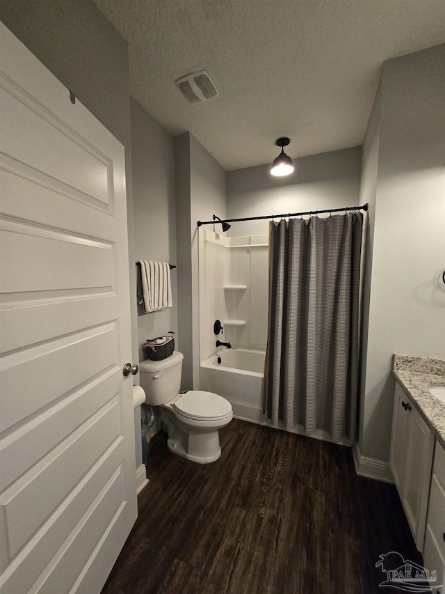 full bathroom featuring vanity, wood finished floors, visible vents, a textured ceiling, and toilet