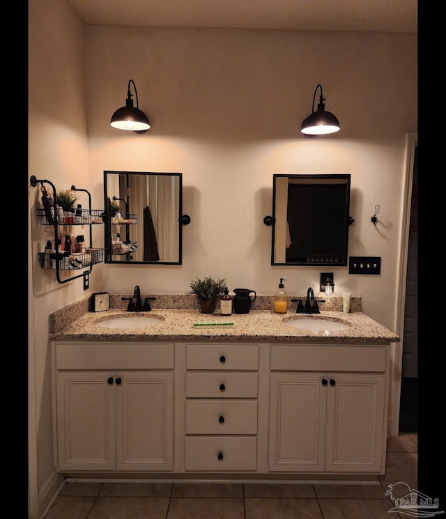 full bathroom featuring tile patterned flooring, double vanity, and a sink