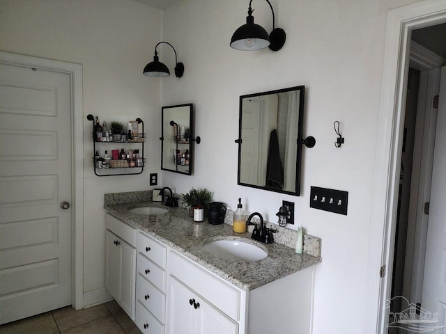 bathroom with a sink, double vanity, and tile patterned floors