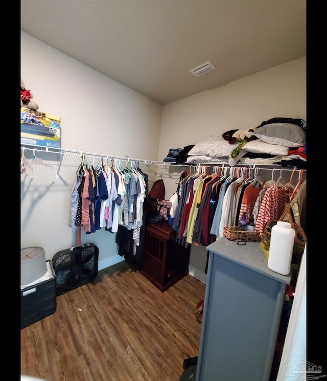 spacious closet with visible vents and wood finished floors