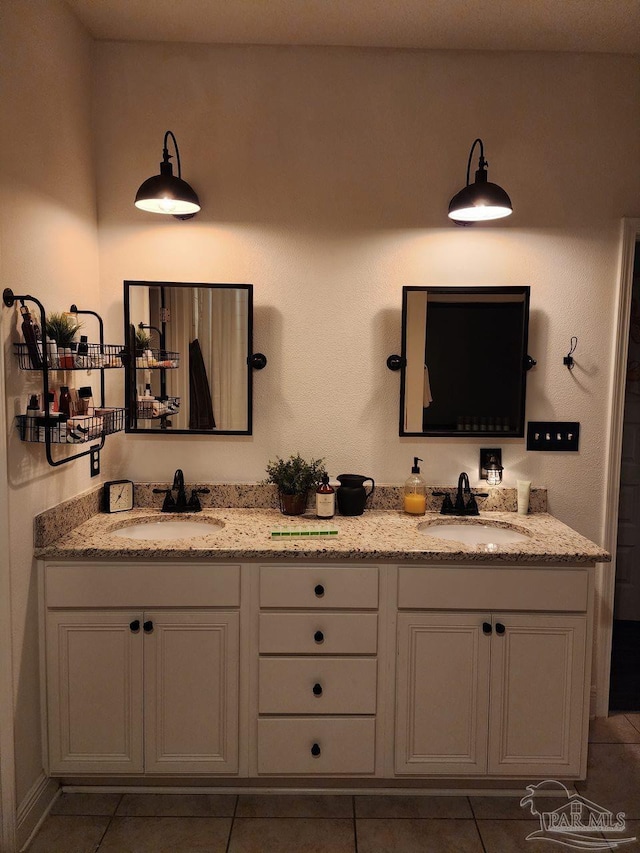 full bathroom featuring a sink, double vanity, and tile patterned flooring