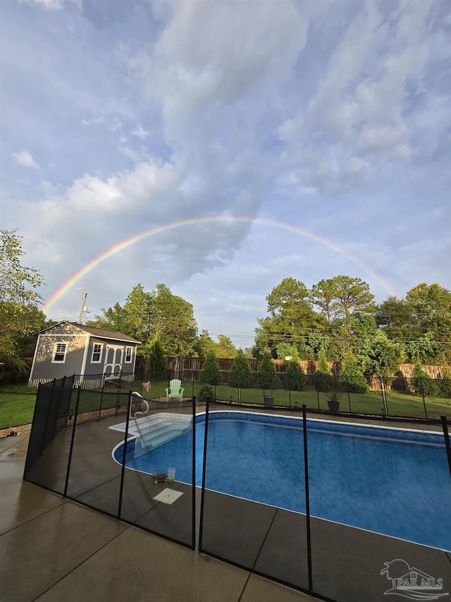 view of pool featuring a fenced in pool, a patio, an outdoor structure, and fence