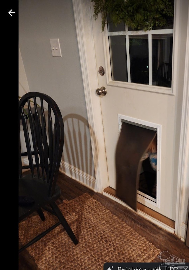 interior space featuring baseboards and wood finished floors