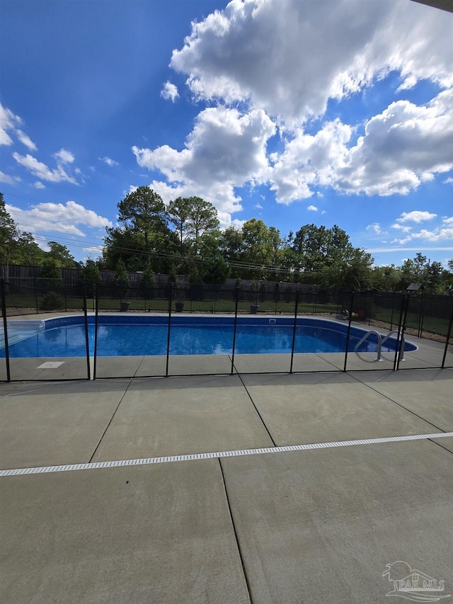 view of swimming pool with a fenced in pool, a patio, and fence