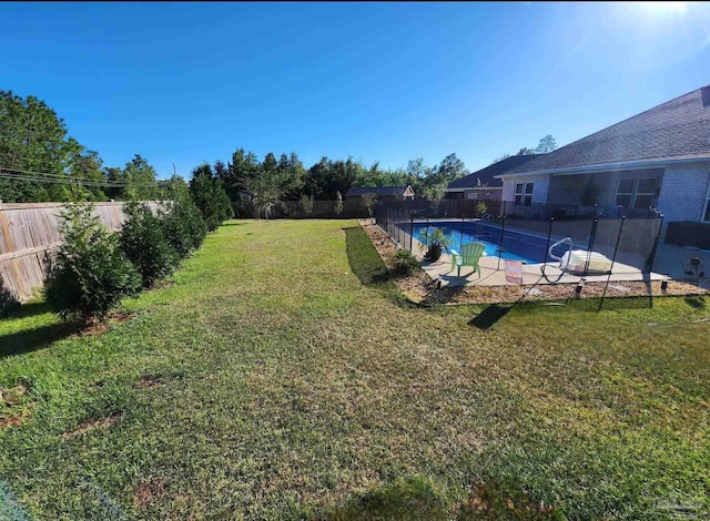 view of yard featuring a fenced in pool, a patio, and a fenced backyard