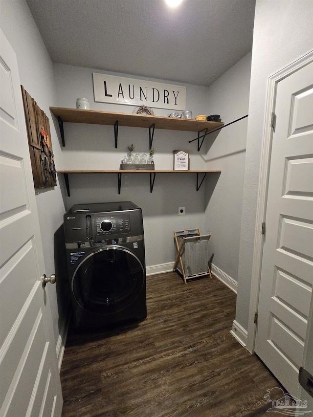 washroom with baseboards, washer / dryer, dark wood-style floors, and laundry area