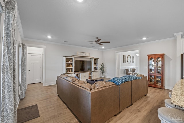 living area with crown molding, recessed lighting, a ceiling fan, light wood-type flooring, and baseboards