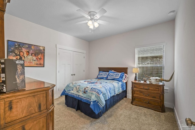 bedroom with ceiling fan, a closet, carpet, and baseboards