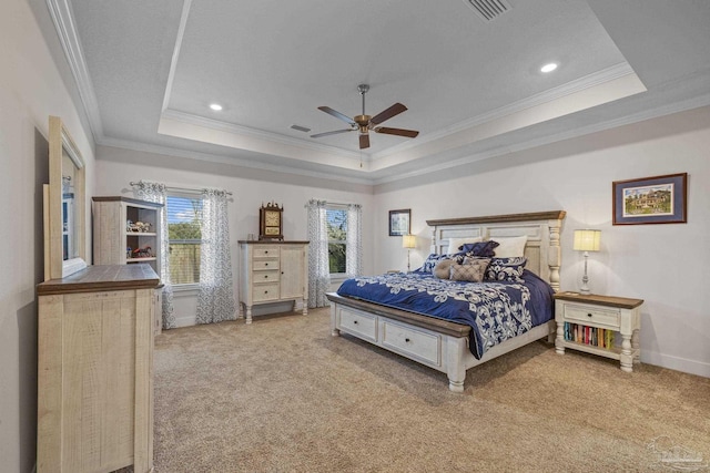 carpeted bedroom with baseboards, visible vents, a tray ceiling, and ornamental molding