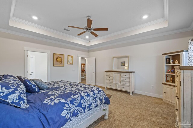 bedroom with ornamental molding, a tray ceiling, carpet, and visible vents