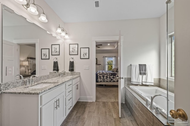 full bathroom with a sink, connected bathroom, and visible vents