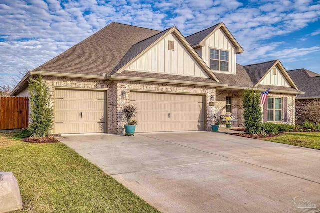 craftsman house with a garage, brick siding, board and batten siding, and a shingled roof