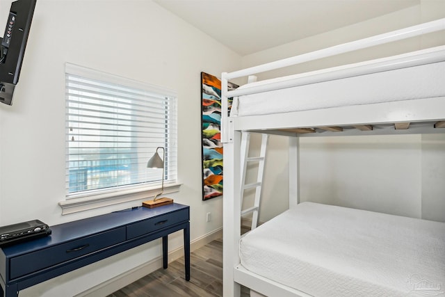 bedroom with dark wood-type flooring