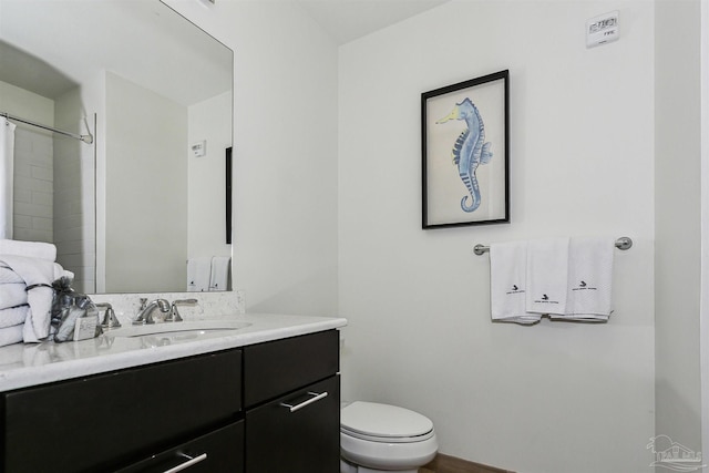 bathroom with vanity, a shower with shower curtain, and toilet