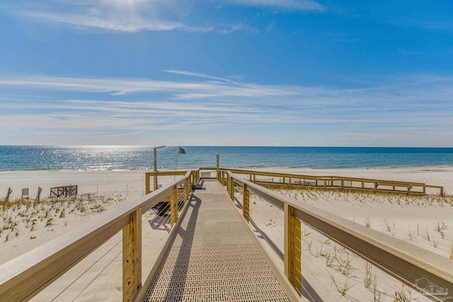 dock area with a water view and a view of the beach