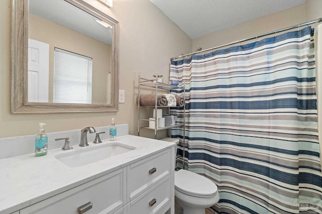 bathroom featuring vanity, a shower with shower curtain, a textured ceiling, and toilet