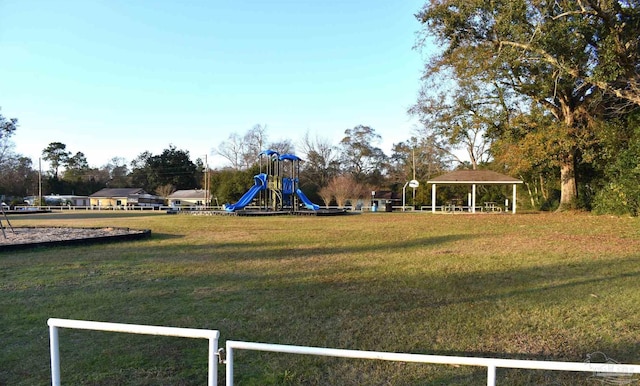 view of playground with a gazebo and a lawn