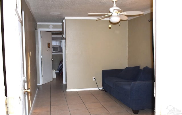 living room featuring tile patterned floors, ceiling fan, and a textured ceiling