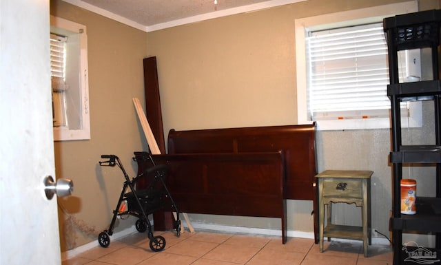 bedroom with light tile patterned floors and crown molding