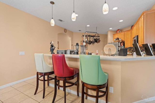 10108 Castleberry Blvd, Pensacola, FL 32526 - bar featuring a textured ceiling, stainless steel microwave, arched walkways, pendant lighting, and recessed lighting