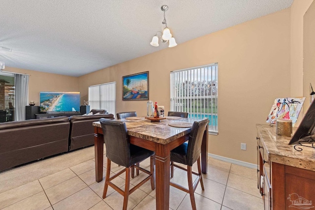 10108 Castleberry Blvd, Pensacola, FL 32526 - dining room with healthy amount of natural light, light tile patterned floors, a chandelier, and a textured ceiling