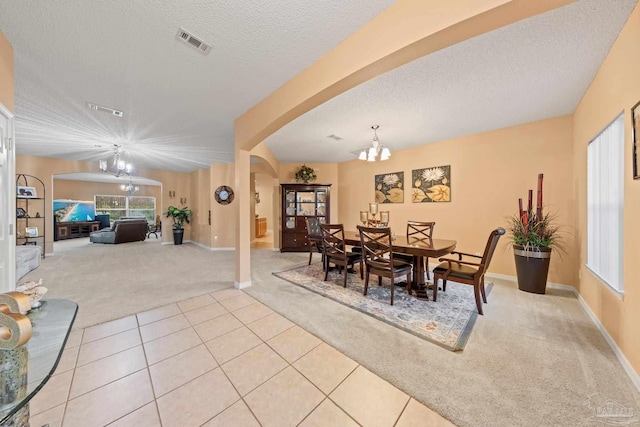 10108 Castleberry Blvd, Pensacola, FL 32526 - dining area featuring light colored carpet, a chandelier, arched walkways, healthy amount of natural light, and a textured ceiling