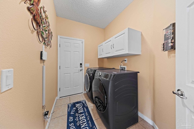 10108 Castleberry Blvd, Pensacola, FL 32526 - laundry room featuring separate washer and dryer, a textured ceiling, light tile patterned flooring, and cabinet space