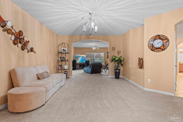 10108 Castleberry Blvd, Pensacola, FL 32526 - carpeted living area featuring arched walkways, a chandelier, and a textured ceiling