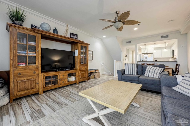 living room featuring crown molding and ceiling fan