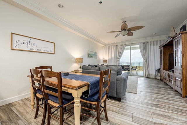 dining room with light hardwood / wood-style flooring, ceiling fan, and crown molding