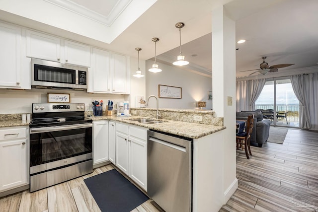 kitchen with sink, ceiling fan, white cabinetry, kitchen peninsula, and stainless steel appliances