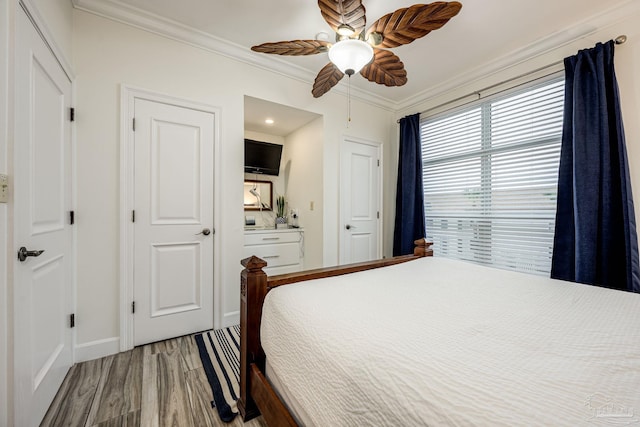 bedroom featuring wood-type flooring, ceiling fan, and crown molding