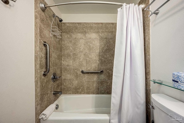 bathroom featuring shower / bath combo and toilet