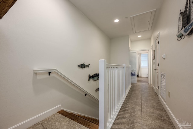 hall with tile patterned floors