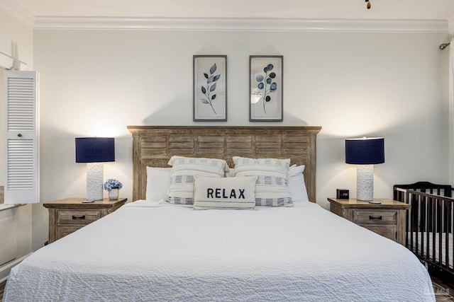 bedroom featuring crown molding and dark hardwood / wood-style floors