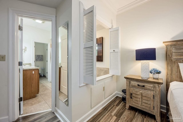 corridor with dark hardwood / wood-style flooring and ornamental molding