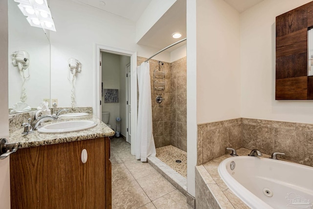 full bathroom with tile patterned flooring, vanity, separate shower and tub, and toilet