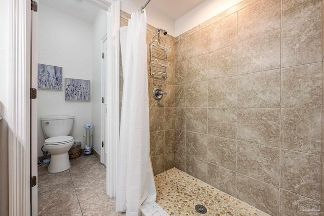 bathroom featuring tile patterned floors, a shower with shower curtain, and toilet