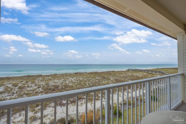 balcony with a beach view and a water view