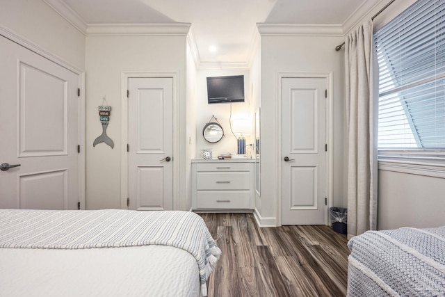 bedroom with dark hardwood / wood-style floors and ornamental molding