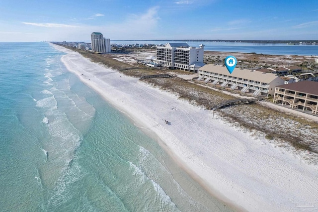 drone / aerial view featuring a beach view and a water view