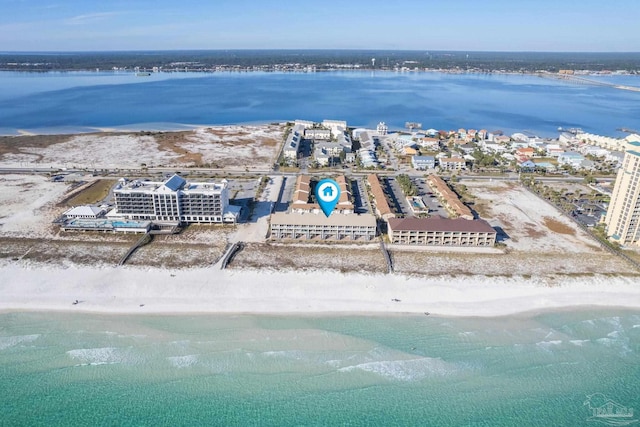 drone / aerial view featuring a water view and a view of the beach