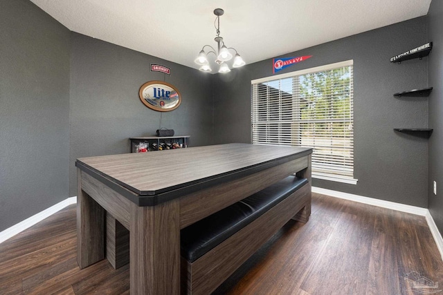 dining room featuring dark wood-type flooring and an inviting chandelier