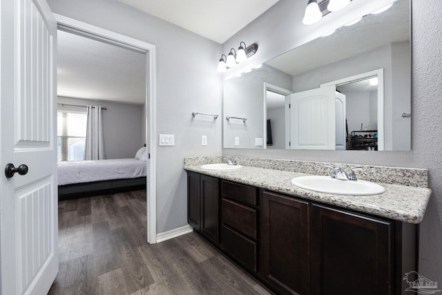 bathroom featuring hardwood / wood-style floors, vanity, and a textured ceiling