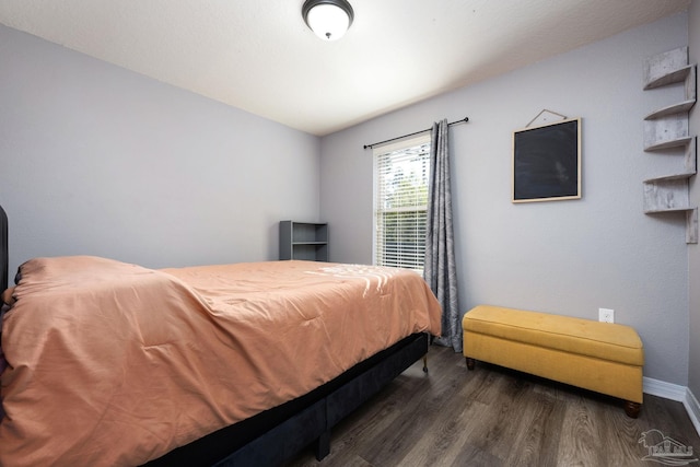 bedroom with dark hardwood / wood-style flooring