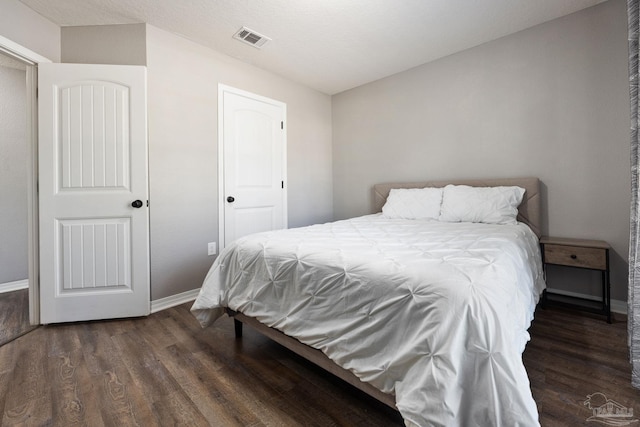 bedroom featuring dark hardwood / wood-style floors