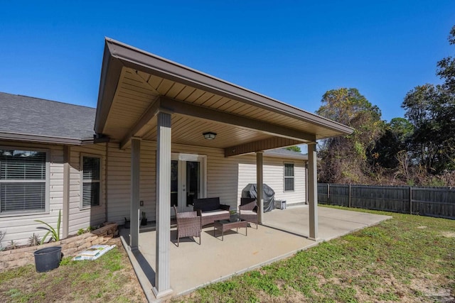 back of property with an outdoor living space, a yard, and a patio